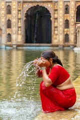 An Indian woman at the Galta Ji Hindu Temple or Monkey Temple in Jaipur, India.