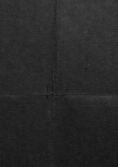 detailed textured image of dark folded paper with a natural rough surface. The visible vertical and...