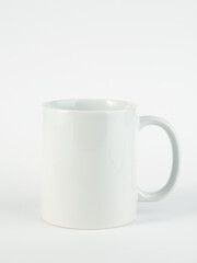 Blank 11oz white mug on isolated background. Mug with black handle and inner part.