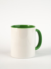 Two-tone 11oz mug on isolated background. Mug with green handle and inner part.