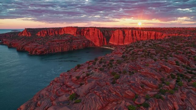Sunset Serenity Over Red Rock Cliffs and Calm Waters  