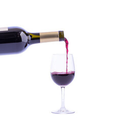 bottle of red wine is being poured into clear wine glass, showcasing rich color and smooth flow of liquid. image captures elegance and simplicity of wine serving