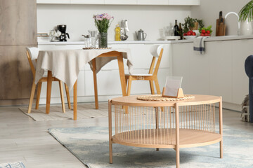 Wooden coffee table in interior of open plan kitchen