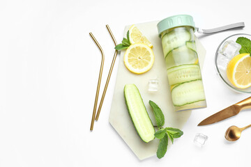 Sports bottle of lemonade with cucumber and mint on white background