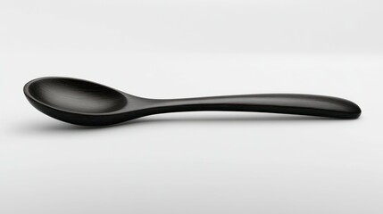 A single dark wooden spoon lies horizontally on a plain white background.