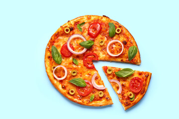 Tasty pizza with olives, tomatoes and basil on blue background