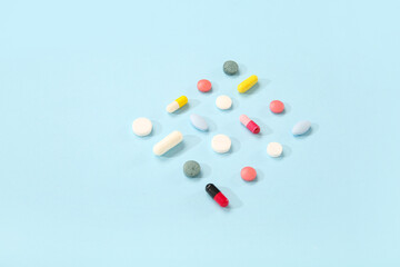 Different pills on blue background