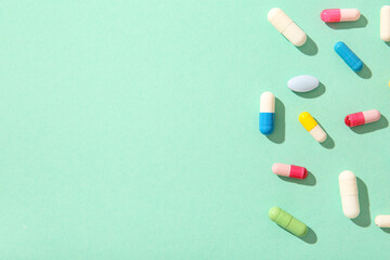 Different pills on turquoise background