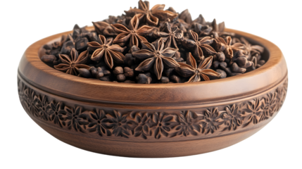 Star anise and peppercorns in a carved wooden bowl