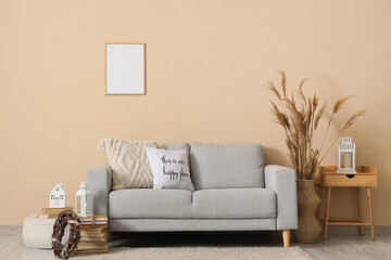 Interior of living room with sofa, table and Christmas lanterns