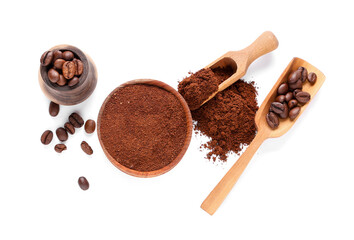 Bowl of coffee powder and wooden scoop with beans on white background