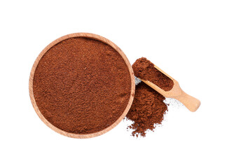 Bowl and wooden scoop with coffee powder on white background