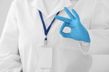 Female doctor showing OK in clinic, closeup