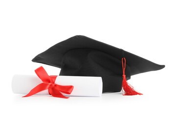 Mortar board and diploma on white background