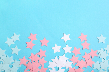 Many stars made of transgender flag colors on blue background