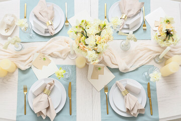 Table setting with beautiful narcissus flowers, top view
