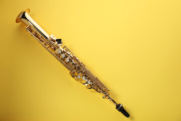 Jazz. One saxophone on yellow background, top view. Space for text