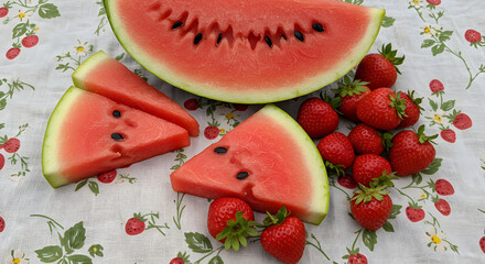 Slices Of Juicy Watermelon And Fresh Strawberries On Floral Textile