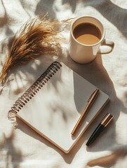 Stylish flat lay composition featuring rustic notebook with botanical elements and coffee cup inviting creativity and relaxation