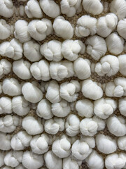 Close-Up of Soft and Fluffy White Textured Fabric with Bubbly Knot Pattern