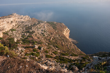 A rocky cliff overlooks the ocean