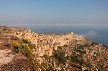 A rocky cliff overlooks the ocean