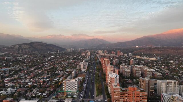 aerial drone footage of the capital of Chile Santiago city at sunset time with mountains on the background
