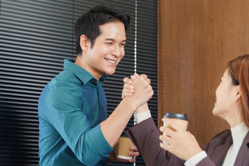 Celebration and Achievement. Colleagues celebrating a successful meeting with engaging conversation and smiles.