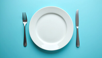 A white plate with a fork and knife on a blue background.