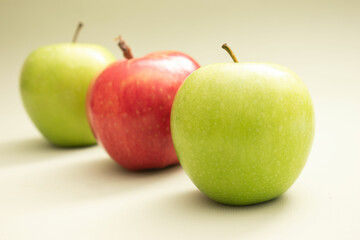 Green and red apples on colorful backgrounds – healthy eating and fruit concept