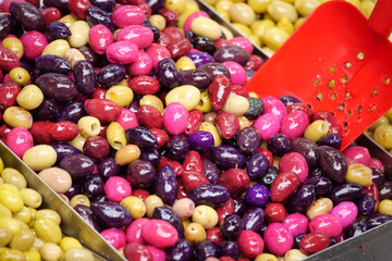 Colorful olives displayed at a market stall in the afternoon