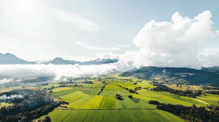Scenic Aerial View of Green Landscape with Mountains and Clouds Under a Clear Sky