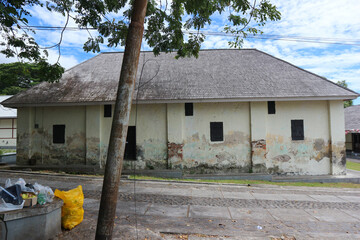 An old warehouse building with an ancient architectural style. Suitable for use as a background for ancient or horror themes  © Hary TS