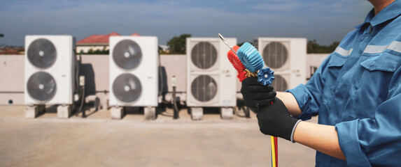 Electrical conditioning service technician using measuring manifold gauge checking HVAC condition...
