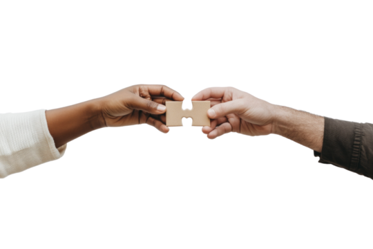 Two hands holding a puzzle piece together