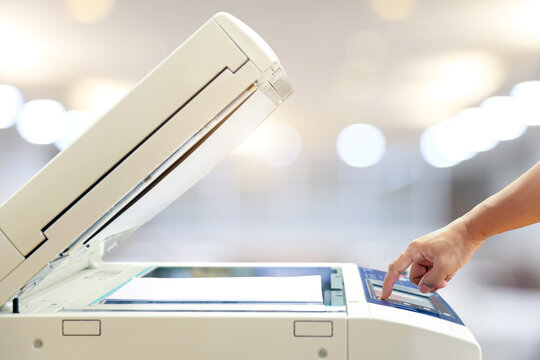 Businessman use photocopy or copier or photocopier in office workplace is equipment for copy duplicate Xerox or scanner to scanning document or printer for printing paper.