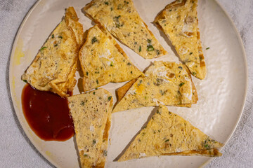 Spiced Indian-style omelette triangles served with tomato ketchup

