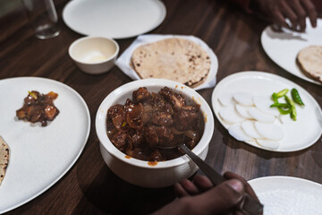 Traditional Indian meal featuring spicy Chicken Chilly served with chapati, sliced radish, and green chilies — a delicious fusion of Indo-Chinese flavor with Indian staples