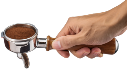 a hand holding a portafilter full of coffee grounds