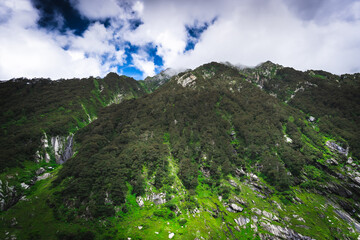 Beautiful landscape shot of a gorgeous Himalayan mountain valley with dense forests during monsoon...