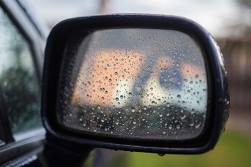 Close-Up View of Car Side Mirror With Raindrops in Focus