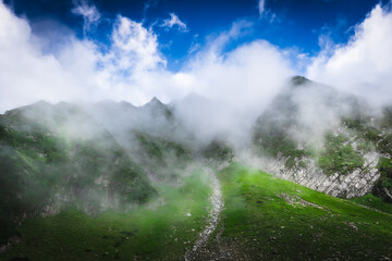 Beautiful landscape shot of a gorgeous Himalayan mountain valley with dense forests during monsoon...