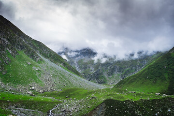 Beautiful landscape shot of a gorgeous Thamsar pass Himalayan mountain valley with dense forests...
