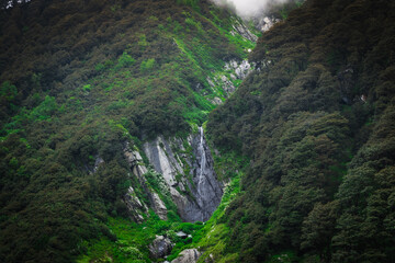 Rustic shot of beautiful mountains with waterfall in Barot Valley, himachal Pradesh.
