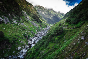 Beautiful landscape shot of a gorgeous Himalayan mountain valley with dense forests during monsoon...