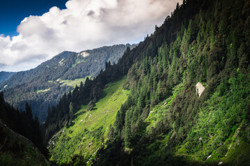 Beautiful landscape shot of a gorgeous Himalayan mountain valley with dense forests during monsoon...
