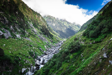 Beautiful landscape shot of a gorgeous Himalayan mountain valley with dense forests during monsoon...