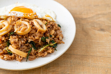 fried rice with squid and basil topped fried egg in Thai style
