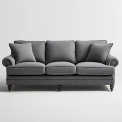 Fototapeta premium Gray upholstered sofa with three seat cushions and pillows