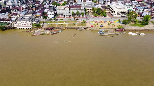 Aerial Majesty of Quibd&oacute;: River, Faith, and Rainforest. Drone views of Quibd&oacute;, Choco, Colombia, featuring the Atrato River, boats, rainforest, and the iconic cathedral. A vibrant mix of nature.